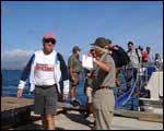 Ray and Barbara (DoC rangers) greet the visitors as they arrive on the island. Click to enlarge : Image - Heurisko Ltd. Camera provided by Lacklands Ltd.